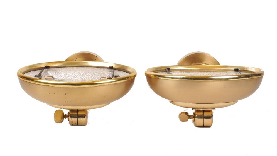 A set of five brass uplighter wall lights, of recent manufacture, with adjustable domed shades on curved arms with circular back plates, 11cm high, 25cm wide, 26cm deep