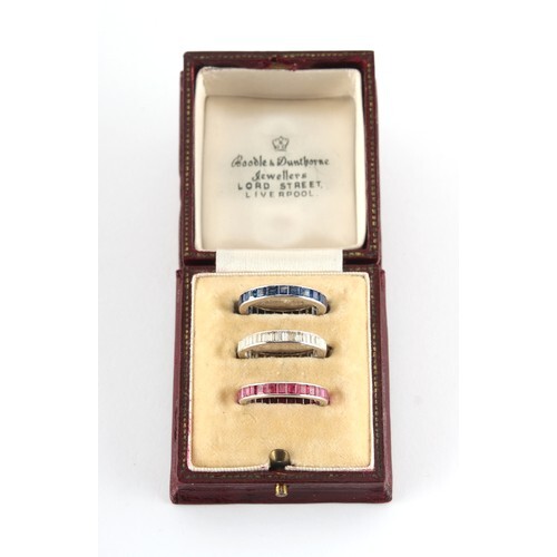 A set of three diamond ruby & sapphire eternity rings, the b...