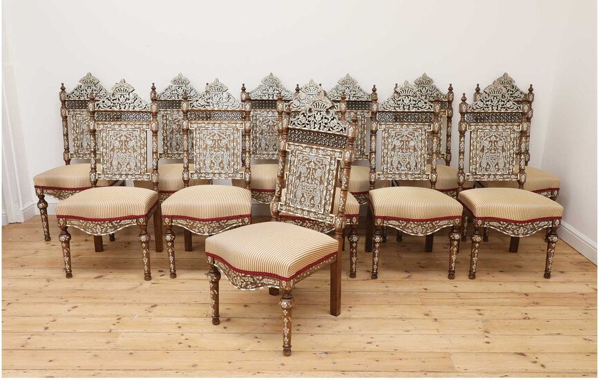 A set of twelve walnut, bone and mother-of-pearl inlaid dining chairs
