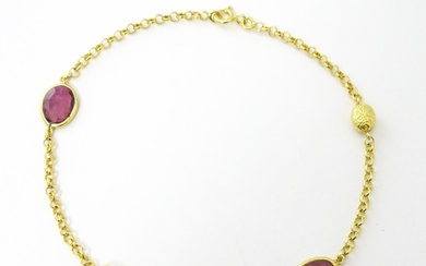 A silver gilt bracelet set with pink tourmaline. Approx 8" l...