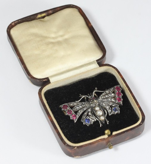 A silver set butterfly brooch set with rose cut diamonds, ru...