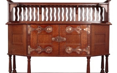ATTRIBUTED TO LIBERTY & CO: AN ARTS AND CRAFTS OAK SIDEBOARD...