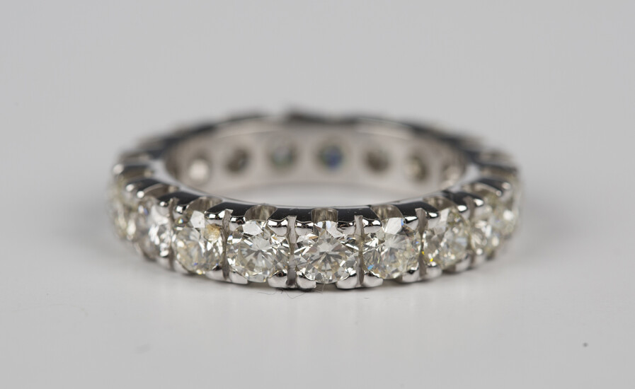An 18ct white gold and diamond eternity ring, claw set with circular cut diamonds, detailed '75