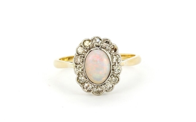 An 18ct yellow gold ring set with a cabochon oval cut opal surrounded by diamonds, (O).