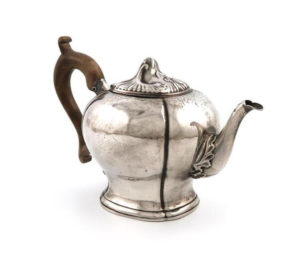 An 18th century Dutch silver teapot, by Matthijis Crayenschot, Amsterdam 1762, inverted baluster form, wooden scroll handle, the hinged cover with fluted and foliate scroll decoration, with a worn armorial, on a raised shaped square foot, length...