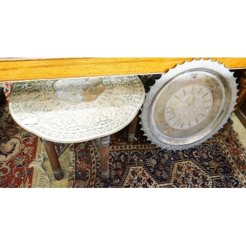 An Indian brass tray top table on folding stand, diameter 74...