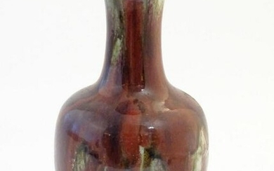 An Oriental high fired sang de boeuf baluster vase.
