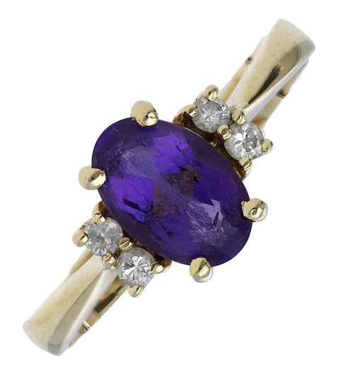 An amethyst and diamond dress ring, set with an oval-cut amethyst between...