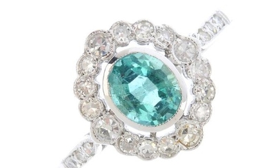 An emerald and diamond dress ring. The oval-shape