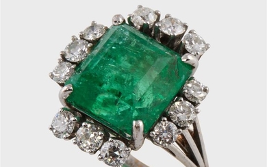 An emerald, diamond, and eighteen karat white gold ring...