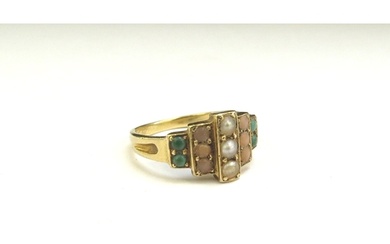 An unmarked gold ring set with turquoise, coral and seed pea...