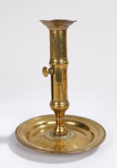 An unusual George II brass ejector candlestick, circa 1740, the pillar stem of seamed