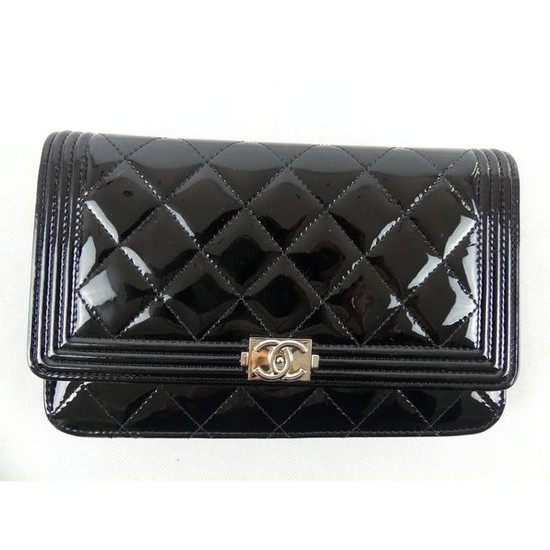CHANEL. "Wallet on chain." Black patent leather quilted...