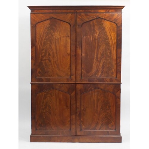 Early 19th century flame mahogany linen press fitted with a ...