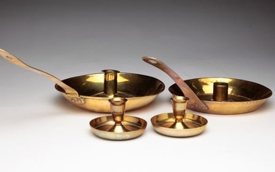 FOUR BRASS CANDLE HOLDERS.