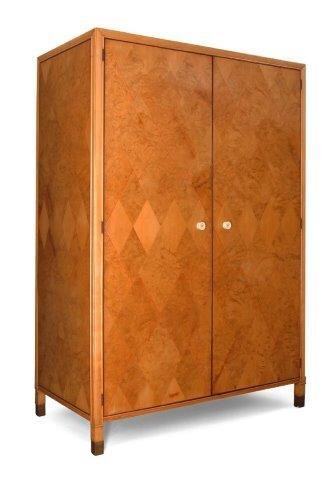 James Henry Sellers (British 1861-1954), a satinwood, burr wood and parquetry double wardrobe, c.1930, The parquetry doors with ebonised moulding, red geometric line inlay and ivory handles, enclosing one shelf, hanging rail and shoe rack, on...