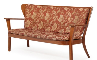 “Kanada”. A sofa bench with stained beech frame, loose cushions with patterned...