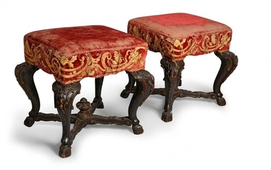 Pair of stools in carved and blackened wood, resting on four angled curved legs decorated with fleurons and with hoof feet, joined by an X-shaped spacer decorated with a vase (one missing).