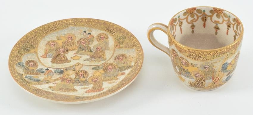 Satsuma cup and saucer. Japan. Meiji period (1868-1912). Decoration of buddhist saints. Signed.