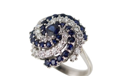 Spiral-shaped gold ring with sapphires and diamonds.