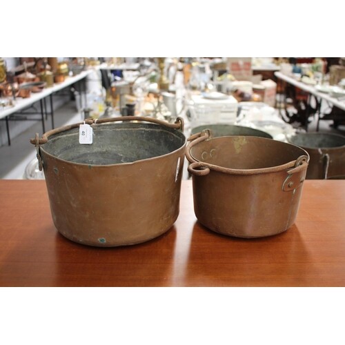 Two antique French copper swing handled pots, with iron hand...