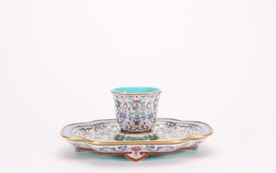 a set of enamel colored cups and saucers with twining floral patterns from the Qianlong period of