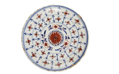 41-Delft: a red and blue two-tone earthenware plate with a...