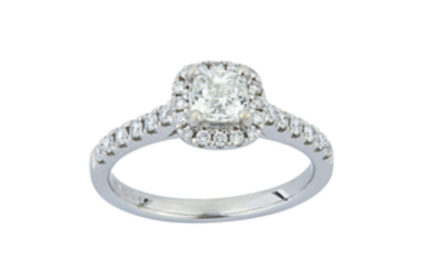 A diamond cluster ring The cushion-shaped diamond, weighing...
