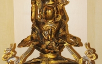 A large Tibetan gilt bronze figure of a tantric deity with consort, H. 50cm.