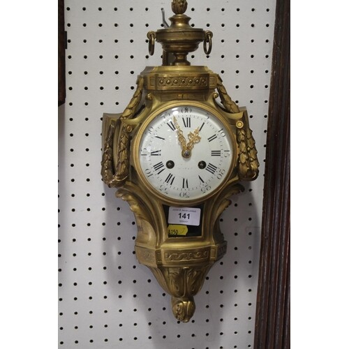A 19th century ormolu cased wall clock with striking movemen...