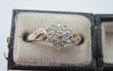 A 9 carat gold and diamond cluster ring consisting of 15pts ...