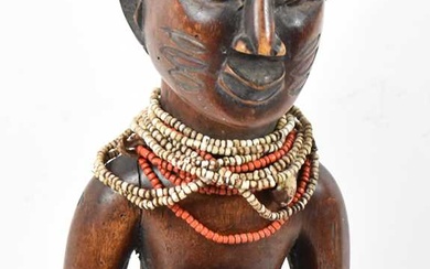 A Baule, Ivory Coast, figure with bead adornments, height 56cm.Provenance:...