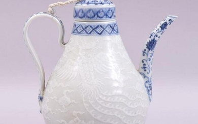 A CHINESE BLUE AND WHITE PORCELAIN WINE EWER, carved