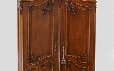 A Carved Walnut Armoire.