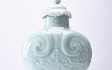 A Chinese carved celadon-glazed Ruyi vase and cover, Qianlong seal mark