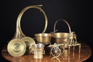 A Collection of Brassware: A coiled hunting horn, a ornamental miniature cannon on carriage, a 17th century style mortar, a 16th century style aquamanile, a 19th century kettle stand with pierced quadrifom top plate, a late 19th/early 20th century