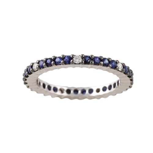 A DIAMOND AND SAPPHIRE ETERNITY RING, set with circular ston...