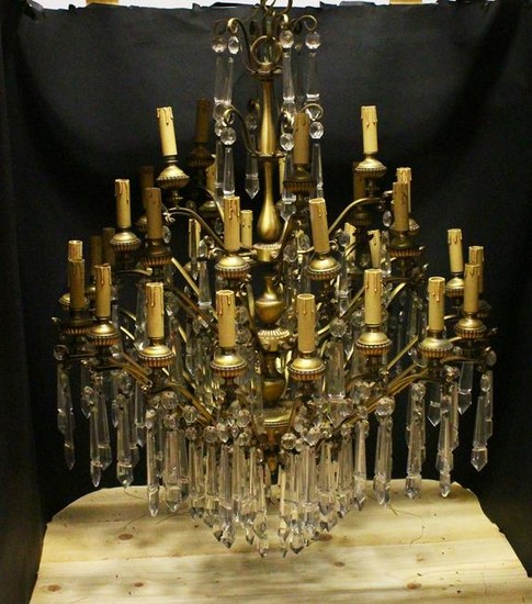 A GOOD LARGE ORNATE BRASS AND CUT GLASS CHANDELIERS, in