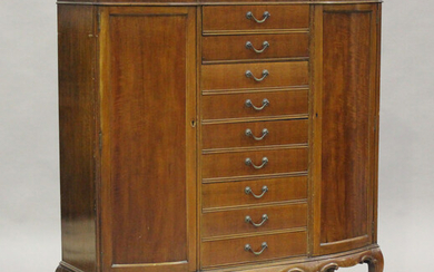 A George V mahogany bowfront side cabinet, fitted with nine central drawers flanked by cupboards, on