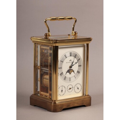 A MATTHEW NORMAN BRASS CASED FOUR DIAL CARRIAGE CLOCK with r...