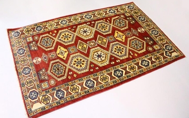 A MODERN PERSIAN RUG, rust ground with two rows of five