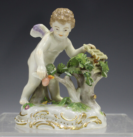 A Meissen figure of Cupid catching flaming hearts, late 19th century, modelled by August Ringer, one