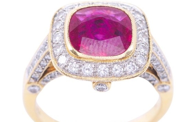 A RUBY AND DIAMOND RING - Featuring a cushion cut ruby weighing an estimated 1.84cts, within a diamond set border, shoulders and gal...