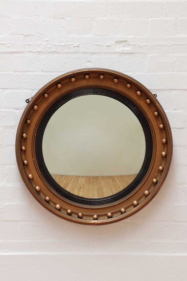 A Regency-style giltwood convex mirror