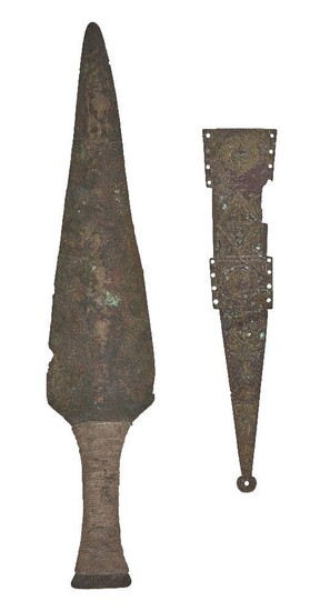 A Roman bronze dagger sheath element, circa 1st century A.D., with the principal part of one side of the sheath remaining, the surface engraved in the first and third decorative fields depicting a female head within a roundel, the second and fourth...
