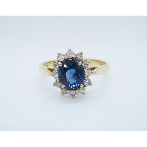A Sapphire and Diamond Cluster Ring claw-set oval-cut sapphi...