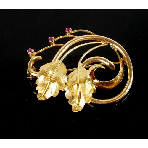 A VINTAGE YELLOW METAL AND RUBY BROOCH A floral spray with r...