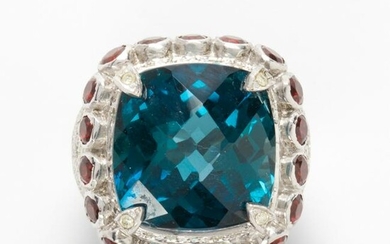 A blue topaz, garnet and diamond ring