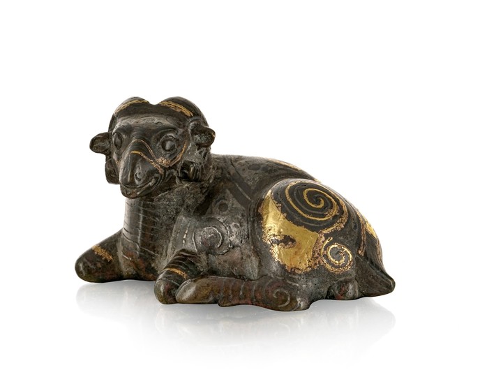 A bronze figure of a reclining ram, China, probably Song dynasty, silver and gilt spiral decorations, 8,5 cm long, C.T. LOO & Cie card