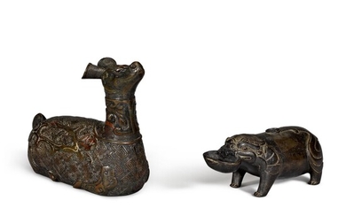 A bronze water dropper in the form of a mythical beast and an inscribed and silver-inlaid bronze figure of a crouching mythical beast Ming dynasty or earlier | 明或更早 銅瑞獸形水注 及 銅錯銀瑞獸 一組兩件